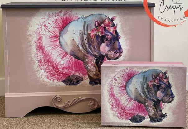Aussie Decor Transfers Luxe paper depicting a watercolour baby hippo wearing a pink tutu with a matching pink bow near her ear. These toy boxes were created by Caroline of Oates Interiors.